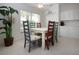 Bright dining area with colorful chairs and lush indoor plants, creating a welcoming atmosphere for meals and relaxation at 5330 Hyland Hills Ave # 2324, Sarasota, FL 34241
