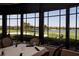 Charming restaurant dining area view overlooking a golf course, pond, and bright blue sky at 5330 Hyland Hills Ave # 2324, Sarasota, FL 34241