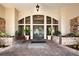 Elegant building entrance, with stone accents, stylish doors and flourishing planter boxes with greenery and colorful flowers at 5330 Hyland Hills Ave # 2324, Sarasota, FL 34241