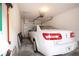 Well-lit garage with a white car parked inside, featuring an automatic door opener and storage options at 5330 Hyland Hills Ave # 2324, Sarasota, FL 34241