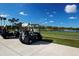 Golf carts parked on the course, ready for a day of golfing on the lush green fairway at 5330 Hyland Hills Ave # 2324, Sarasota, FL 34241