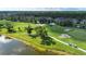 Scenic view of a lush green golf course with mature trees and a peaceful pond, creating a tranquil setting at 5330 Hyland Hills Ave # 2324, Sarasota, FL 34241