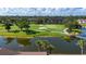 Aerial view of the verdant golf course with serene pond and lush landscaping at 5330 Hyland Hills Ave # 2324, Sarasota, FL 34241