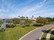 Scenic golf course view with lush green fairways, a tranquil lake, and a charming clubhouse in the background at 5330 Hyland Hills Ave # 2324, Sarasota, FL 34241