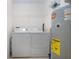 Functional laundry room with washer, dryer, and water heater at 5330 Hyland Hills Ave # 2324, Sarasota, FL 34241