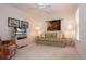 Cozy living room featuring a plaid sofa, floral armchair, and entertainment center at 5330 Hyland Hills Ave # 2324, Sarasota, FL 34241
