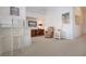 Inviting living room features a cozy recliner, a wooden desk, and white cabinets, offering a comfortable and functional space at 5330 Hyland Hills Ave # 2324, Sarasota, FL 34241