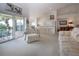 Spacious living room featuring access to balcony and open view to kitchen with bar seating at 5330 Hyland Hills Ave # 2324, Sarasota, FL 34241