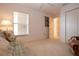 Bright living room featuring neutral carpet and a window with blinds for natural light at 5330 Hyland Hills Ave # 2324, Sarasota, FL 34241
