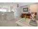 Cozy living room with bright decor and an open kitchen with modern white cabinets at 5330 Hyland Hills Ave # 2324, Sarasota, FL 34241