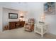 Inviting living room features a cozy recliner, a wooden desk, and white cabinets, offering a comfortable and functional space at 5330 Hyland Hills Ave # 2324, Sarasota, FL 34241