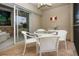 Charming patio featuring a white wicker table set with comfortable chairs and a serene outdoor view at 5330 Hyland Hills Ave # 2324, Sarasota, FL 34241