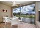 Serene screened patio overlooking golf course and pond, complete with patio furniture and decor at 5330 Hyland Hills Ave # 2324, Sarasota, FL 34241
