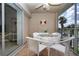 Inviting screened patio with tranquil view, furnished with a dining table and chairs at 5330 Hyland Hills Ave # 2324, Sarasota, FL 34241
