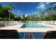 Beautiful community pool with lounge chairs and lush landscaping on a sunny day at 5330 Hyland Hills Ave # 2324, Sarasota, FL 34241