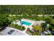 Aerial view of a community pool with many lounge chairs and a nearby parking area at 5330 Hyland Hills Ave # 2324, Sarasota, FL 34241