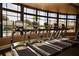 Modern treadmills aligned with a view of the swimming pool and bright sunlight at 5330 Hyland Hills Ave # 2324, Sarasota, FL 34241