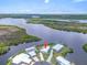 Stunning aerial view of waterfront home with private dock and lush landscaping at 550 Tampico Dr, North Port, FL 34287