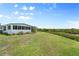 Spacious backyard with a well-maintained lawn and verdant greenery along the waterfront at 550 Tampico Dr, North Port, FL 34287