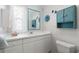 Bright bathroom featuring a white vanity, neutral walls, and blue accents at 550 Tampico Dr, North Port, FL 34287