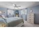 Cozy bedroom with two windows, a ceiling fan and blue walls at 550 Tampico Dr, North Port, FL 34287