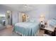 Comfortable bedroom featuring a large bed, soft carpet, and an ensuite bathroom at 550 Tampico Dr, North Port, FL 34287