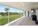 Spacious carport area with views of the lush greenery along the waterfront, leading to the residence at 550 Tampico Dr, North Port, FL 34287