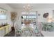 Bright dining room with a glass table, chandelier, and views of the enclosed porch at 550 Tampico Dr, North Port, FL 34287