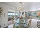 Charming dining room featuring a glass-top table, coastal decor, and seamless access to the sunroom at 550 Tampico Dr, North Port, FL 34287