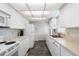 Efficient kitchen with white cabinetry and appliances, plus ample counter space and storage at 550 Tampico Dr, North Port, FL 34287
