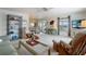Inviting living room with comfortable seating, a decorative bookshelf, and access to the dining area at 550 Tampico Dr, North Port, FL 34287