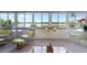 Bright sunroom with large windows offering serene water views and comfortable seating arrangements at 550 Tampico Dr, North Port, FL 34287