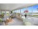 Inviting sunroom with panoramic water views, comfortable seating, and lots of natural light at 550 Tampico Dr, North Port, FL 34287