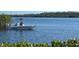 Relaxing water view featuring a boater and a scenic tree-lined shoreline at 550 Tampico Dr, North Port, FL 34287
