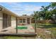 Back of house with a small weathered deck overlooking the fenced yard at 5639 Blount Ave, Sarasota, FL 34231
