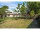 Large backyard with mature trees and a partial fence at 5639 Blount Ave, Sarasota, FL 34231