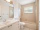 An airy bathroom has a shower-tub combo and a neutral vanity at 5639 Blount Ave, Sarasota, FL 34231
