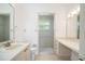 Bright bathroom shows large mirror and tiled walk-in shower at 5639 Blount Ave, Sarasota, FL 34231