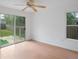 A bright bedroom featuring wood-look floors and sliding glass door access to the backyard at 5639 Blount Ave, Sarasota, FL 34231