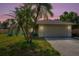 Charming home featuring a two-car garage, well-manicured lawn and mature trees at 5639 Blount Ave, Sarasota, FL 34231