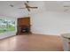 Sun-filled living room with brick fireplace, vaulted ceiling, and wood flooring, creating a warm and inviting ambiance at 5639 Blount Ave, Sarasota, FL 34231