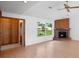 Bright living room boasting wood floors, a brick fireplace, and large windows overlooking the landscaped front yard at 5639 Blount Ave, Sarasota, FL 34231