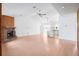Open living room featuring vaulted ceiling, brick fireplace, and abundant natural light, seamlessly connecting to the kitchen at 5639 Blount Ave, Sarasota, FL 34231