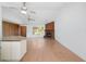 Spacious living room with open layout, featuring a brick fireplace, wood accents, and access to the kitchen at 5639 Blount Ave, Sarasota, FL 34231