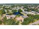 Aerial view of home in a neighborhood with a pond and mature trees at 5698 Country Walk Ln, Sarasota, FL 34233
