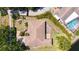 Birds eye view of beautiful home in a manicured lawn featuring a brick patio and mature landscaping at 5698 Country Walk Ln, Sarasota, FL 34233
