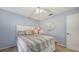 Cozy bedroom featuring soft blue walls, ceiling fan, and a comfortable bed, creating a relaxing atmosphere at 5698 Country Walk Ln, Sarasota, FL 34233