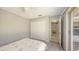 Neutral bedroom featuring double closets, a hallway entrance, and outside entry at 5698 Country Walk Ln, Sarasota, FL 34233