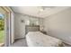 Bright bedroom with a sliding door to the outdoors and a neutral color scheme at 5698 Country Walk Ln, Sarasota, FL 34233