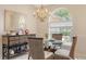 Cozy dining area featuring a glass table, wicker chairs, and an arched window, perfect for casual meals at 5698 Country Walk Ln, Sarasota, FL 34233